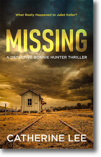 Book Cover for Missing (A Detective Bonnie Hunter Thriller) by author Catherine Lee, showing a set of rusted abandoned railway tracks running into the distance through dry grass, past a dilapidated old building. A stormy sky threatens overhead signals wild weather coming.